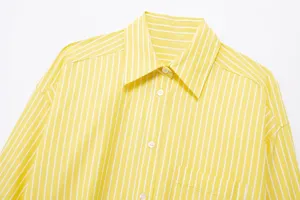 Close-up detail view of women yellow and white striped casual shirt collar and front buttons.