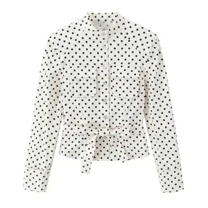 Cream and black polka dot long sleeve blouse detail, button front and waist tie belt.