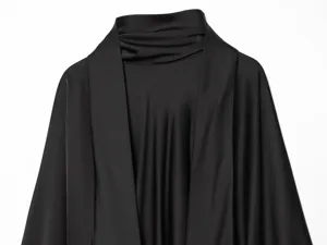 Black satin scarf collar dress detail showing luxurious drape and smooth fabric texture close up
