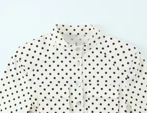 Polka dot long sleeve shirt detail view, elegant mandarin collar, classic button design.