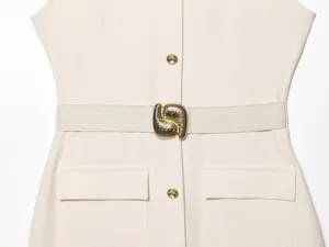 Beige sleeveless midi dress detail featuring a gold metallic buckle belt and chic buttons.