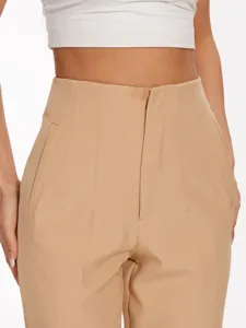 Close-up detail of women high waist casual suit trousers front pleat design beige.