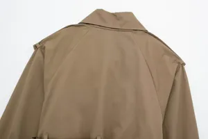 Detail view of khaki trench coat back, featuring classic collar and raglan sleeves.