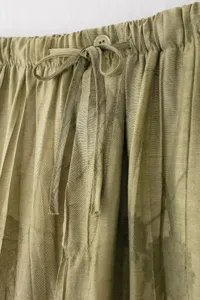Vue détaillée de pantalon casual pour femme avec taille élastique, cordon et bouton.