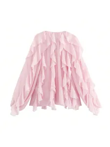 Pink ruffled blouse detail showing layered cascading fabric and delicate long sleeves close-up.