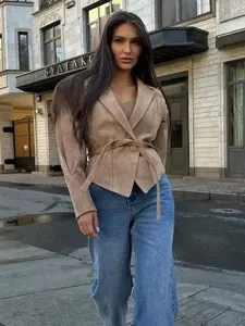 Detailed view of women's khaki suede slim fit jacket with waist strap, casual style.