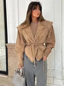Detail view of women's suede belted slim jacket, stylish autumn fashion outerwear.