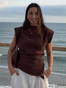 Detailed shot of a stylish brown sleeveless top with shoulder pads and asymmetric hem.