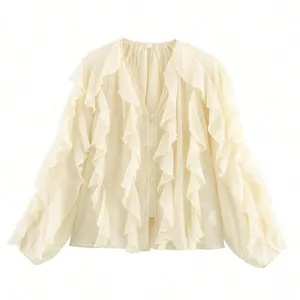 Close-up detail of women's V-neck layered ruffle long sleeve shirt in classic beige color.