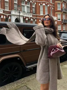 European style knit coat and scarf outfit detail, elegant women outerwear fashion street look.