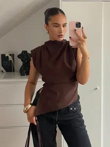 Brown sleeveless asymmetrical draped top with padded shoulders for stylish women spring outfit.