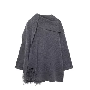 Dark grey knitted coat detail showcasing soft fabric texture and matching fringed scarf design.