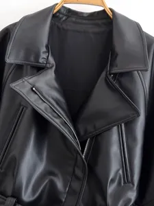 Closeup detail of womens black faux leather jacket collar zipper and lapel design.