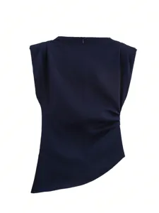 Detailed view of dark blue sleeveless top with shoulder pads and side pleats asymmetric hem.