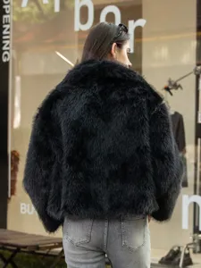 Detail view of black faux fur lapel jacket back side, winter cozy fluffy outerwear fashion.