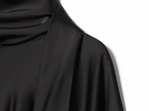 Close-up detail of a chic black satin scarf collar long sleeve dress, elegant and smooth.