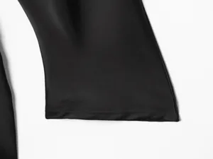 Close-up detail of black satin long sleeve dress cuff, fine stitching and smooth fabric.