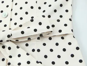 Polka dot shirt dress detail view, classic pattern close-up, premium fabric texture style.