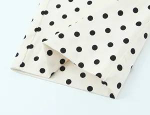 Close up view of stylish polka dot fabric detail showing soft texture and fine stitching lines.
