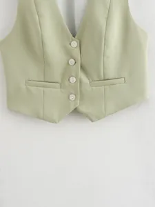 Close-up of a trendy light green sleeveless vest with V-neck, buttons, and chic front pocket details.