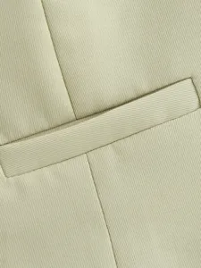 Close-up detail view of women's casual vest pocket and fine twill fabric texture.