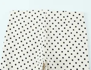 Detailed view of women's chic polka dot high waist trousers, stylish casual daily wear.