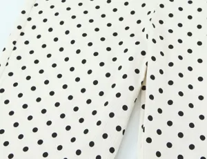 Close-up view of elegant black and white polka dot fabric detail for fashion women clothing.
