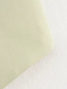 Detailed macro close-up shot of light green ribbed fabric for women casual vest top.