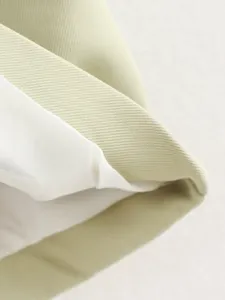 Detailed shot of trendy women's summer vest fabric texture, high quality crop top detail.
