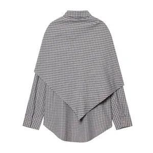 Detail view of the French plaid long-sleeve shirt with chic cape overlay and lapel design.