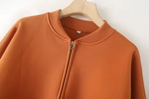 Orange zip-up bomber jacket detail, casual long sleeve sweatshirt outerwear with metal zipper.