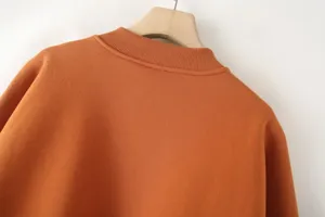Orange bomber jacket sweatshirt collar detail, knit rib collar, casual outerwear.