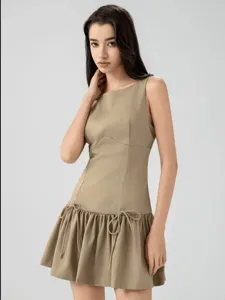 Sleeveless mini dress with bow details at the hem, perfect for casual summer resort wear.