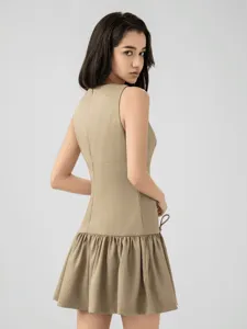 Khaki sleeveless mini dress with dropped waist and ruffled hem, perfect for casual summer wear.