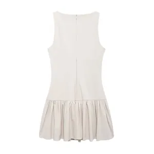 Back detail view of a chic beige sleeveless mini dress with a dropped waist ruffled hem.