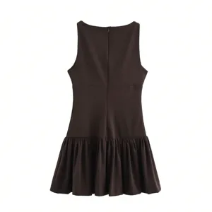Detail view of dark brown sleeveless short dress featuring a back zipper and pleated hem design.