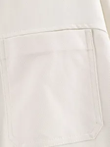 White twill fabric shirt chest pocket close-up detail showcasing neat fine stitching.