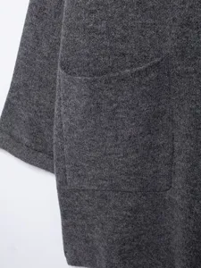 Dark grey knit cardigan coat detail showing pocket and sleeve texture close up view.