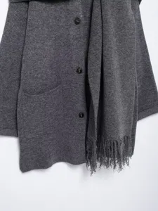 Grey knit cardigan detail view, textured fabric with chic scarf and button closure.