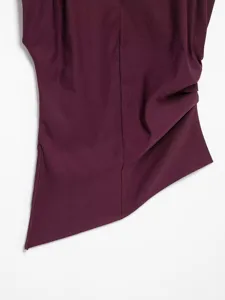 Close-up of asymmetrical purple draped top showing fine fabric texture and side gathering details.