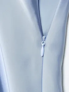 Close-up detail shot of smooth satin dress zipper and soft fabric texture, elegant style.