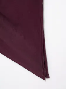 Burgundy fabric detail of women asymmetric top hem texture close-up view stitching