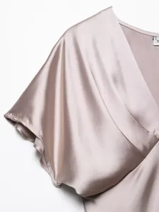 Women's silk satin V-neck short sleeve dress detail shot, elegant spring summer fashion style.
