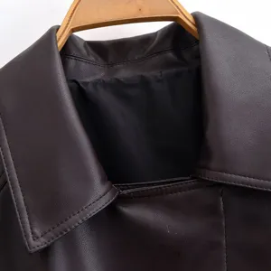 Close-up detail of stylish women's PU leather jacket collar with fine stitching texture.