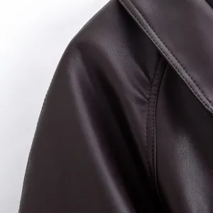 Close-up detail of women's faux leather trench coat shoulder, showing fine texture and stitching.