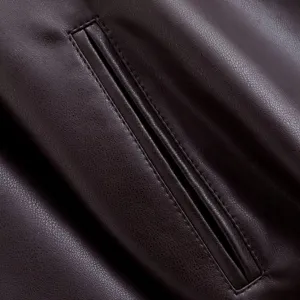 Close-up detail of women faux leather trench coat pocket, premium texture and neat stitching.