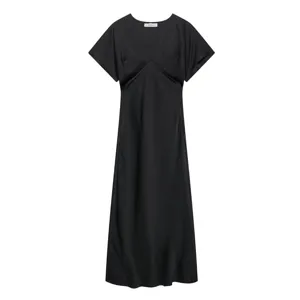 Detailed close-up of the black satin dress, showing the sleek V-neckline and smooth texture.