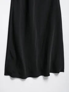Elegant black satin dress detail, smooth texture and beautiful drape for chic style.