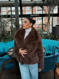 Stylish women's brown faux fur lapel jacket, loose winter warm outerwear for daily fashion look.