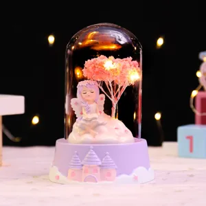 Close-up detail of the cute fairy glass dome night light with warm LED star lights.